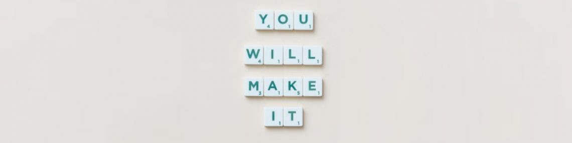 Motivational phrase 'You Will Make It' made from Scrabble tiles on a neutral background.